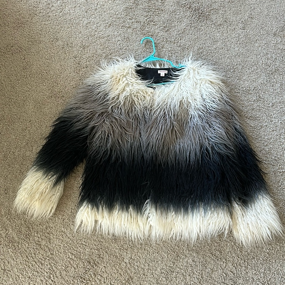 Large fake shag jacket with the colors white, gray & black.